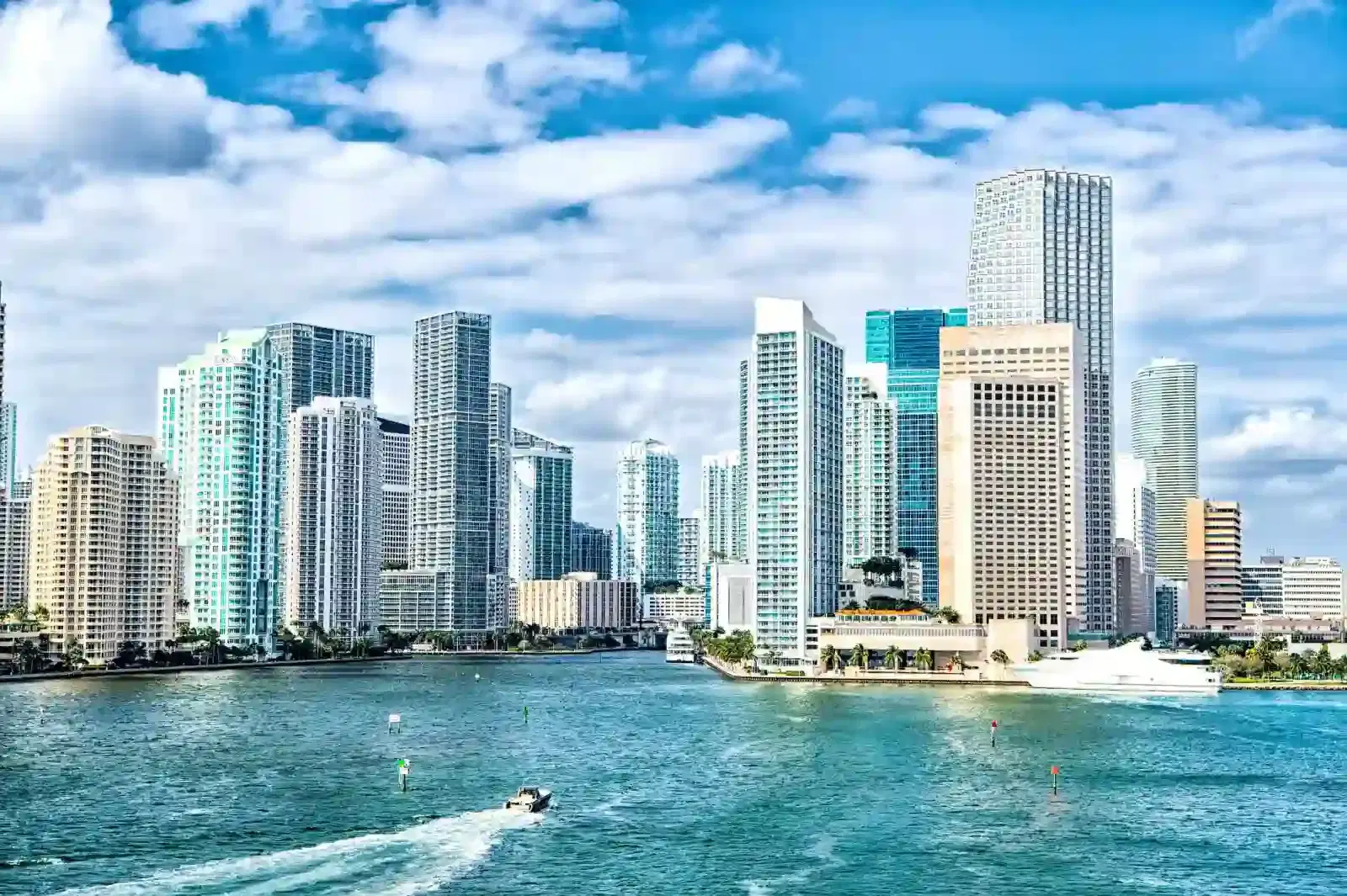 miami skyline. Yachts sail on sea water to city